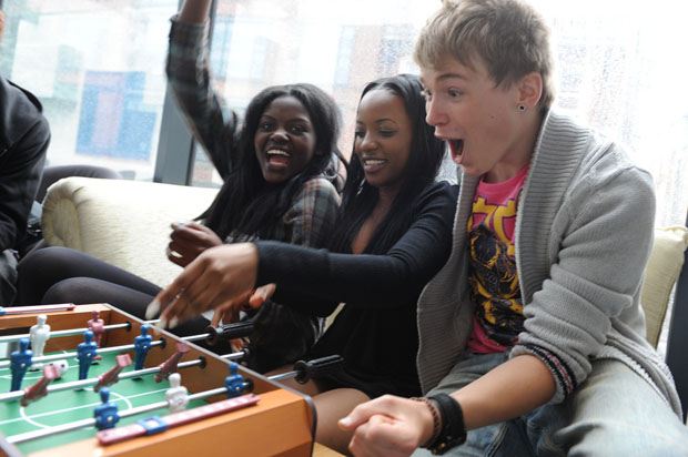 3 young people winning at table football