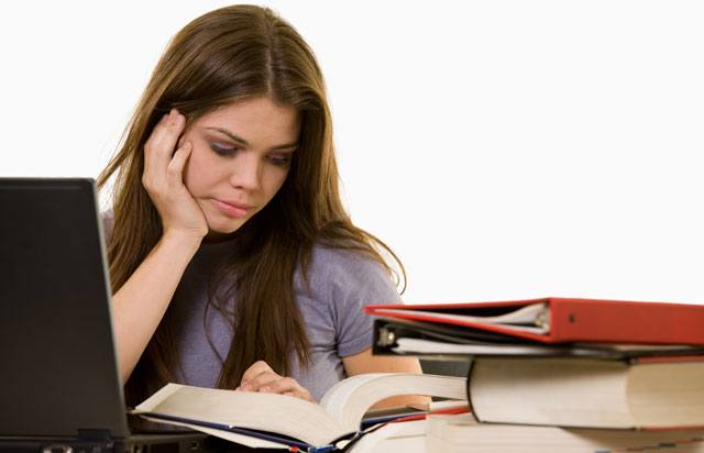 Girl studying with books and laptop