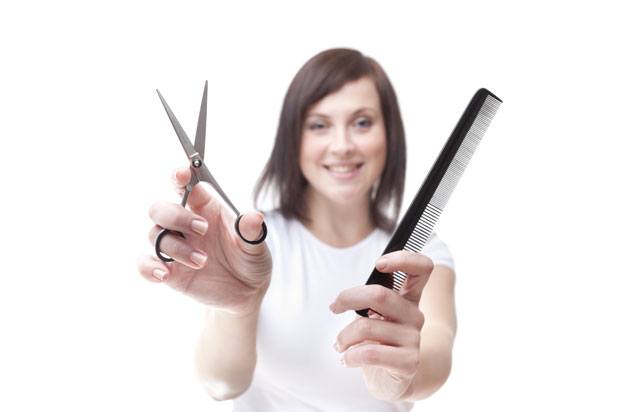 Girl holding scissors and comb for hairdressing