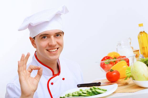 Chef holding a plate of cucumber