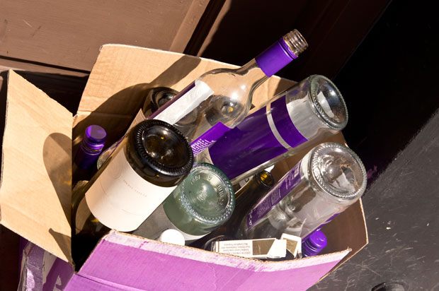 Empty wine bottles in a cardboard box
