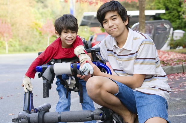 young man with disabled brother