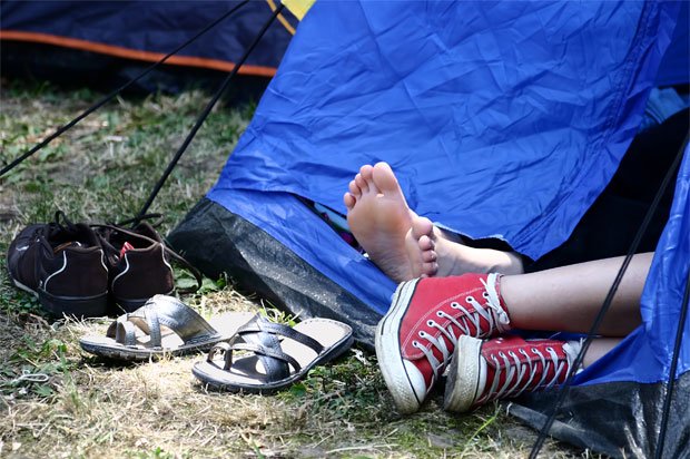 Two pairs of feet poking out of a tent