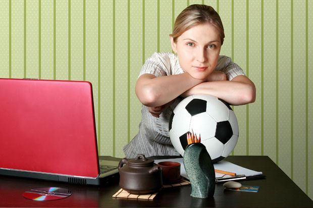 Woman with a football in the office.