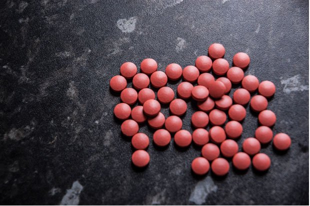 Pink pills on a kitchen counter