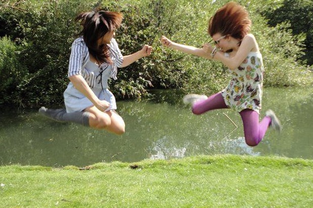 two girls jumping in the air