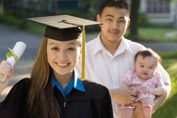 Woman graduating with baby