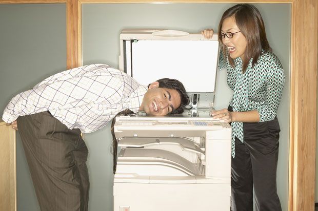 boy and girl messing with the photocopier