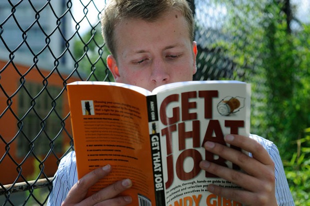 Boy reading an employment book