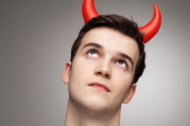 Man looking angelic with devil horns.
