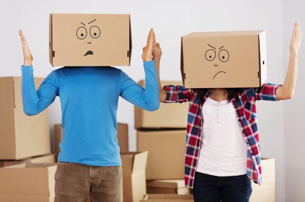 Couple with moving boxes on their heads