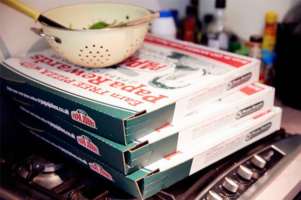 Pile of pizza boxes with colander on top