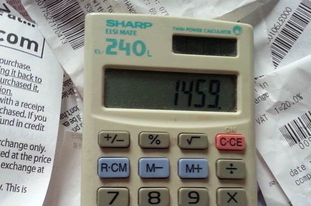 calculator surrounded by receipts
