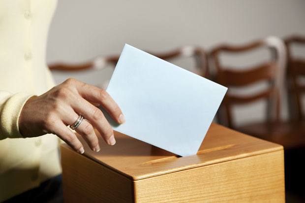 Woman using ballot box