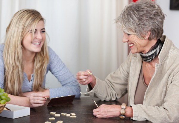 teenager and granny playing scrabble