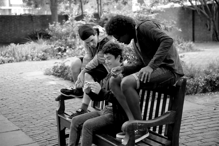 Group of young men looking at a mobile phone