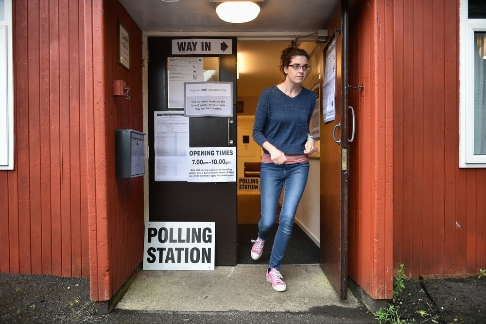 A young woman leaves a polling station