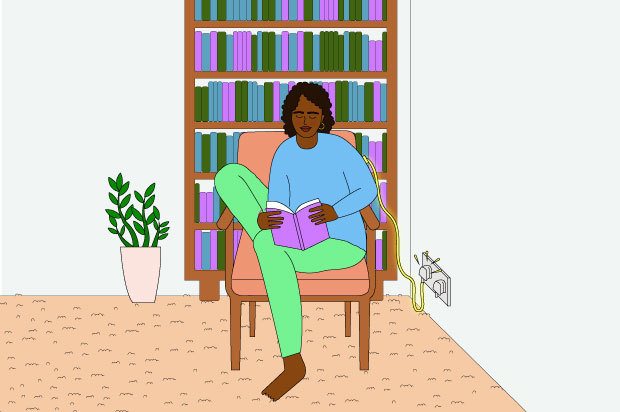 Illustration shows a young woman reading in a chair. She is wearing a blue top and green trousers and there is a charger plugged in behind her
