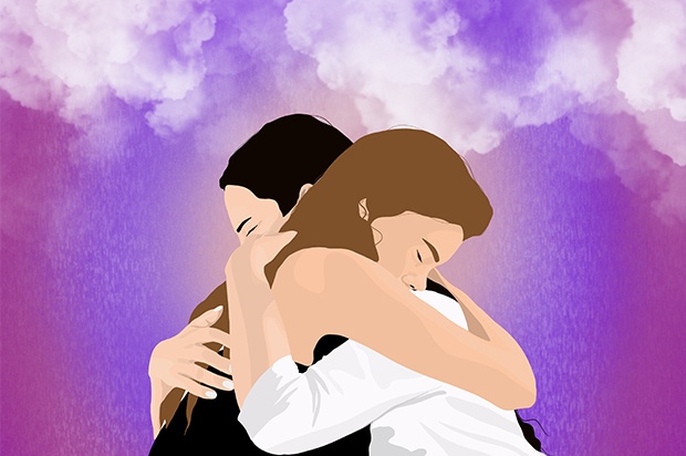 Two young people are hugging each other